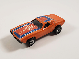 My Dixie Challenger Hot Wheels car. An orange Dodge Challenger with red, white, and blue paint on the hood and roof. The hood reads, "Dixie Challenger" and "426 Hemi"