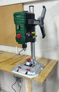 Pillar drill attached to the bench