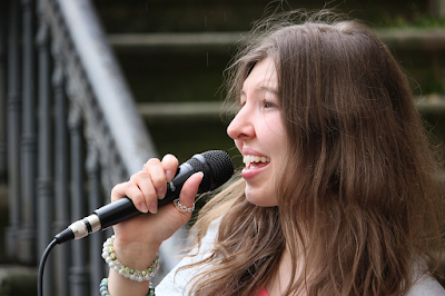 a woman with a messy hair holding a mic