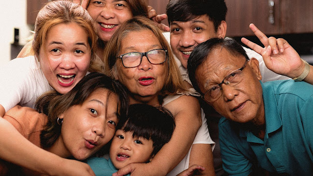 An asian family posing for a photo.