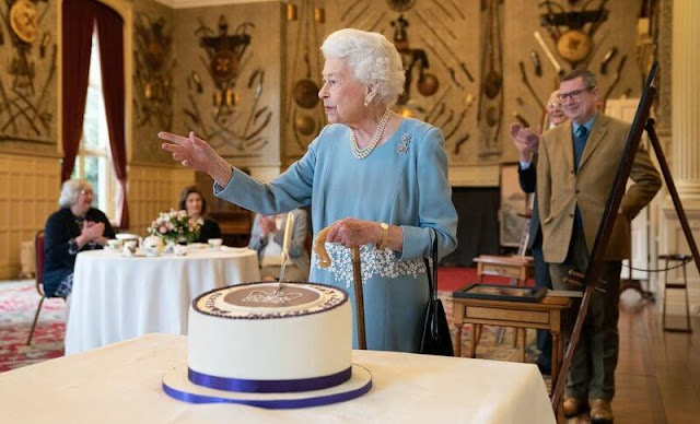 Queen Elizabeth wore a wedgewood and a blue crepe white brocade embroidered dress by Angela Kelly