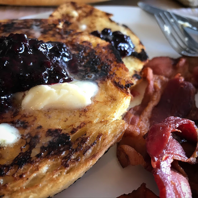 Pancakes with berries and butter and bacon