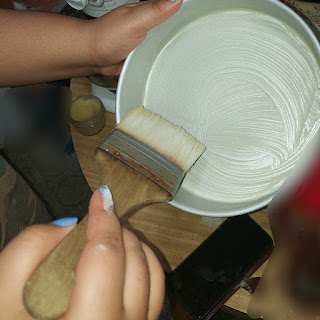 Using a pastry brush to smear a Cake pan with Cake Goop