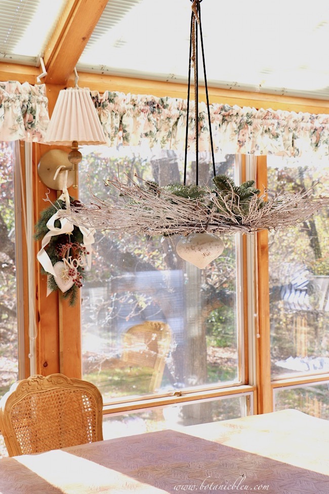 For a twist on Christmas wreaths, hang a horizontal wreath above a dining table.