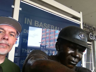 Bruce Nesmith with a statue of Tony Oliva