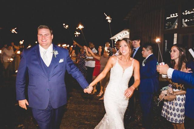 bride and groom walking through sparkler exit