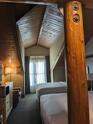 Airy room with exposed wood beams at Arbor Day Farm's Lied Lodge