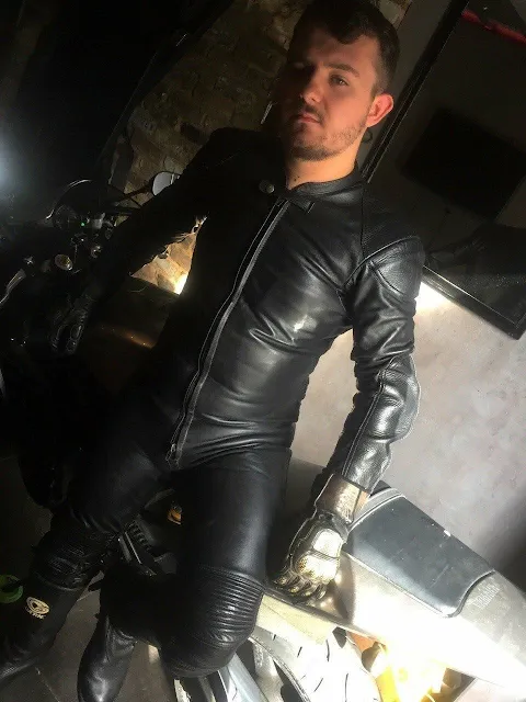 Handsome guy in black leather biker suit