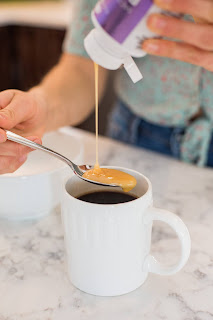 Photo of Complete Collagen Plus supplement being added to a mug of coffe
