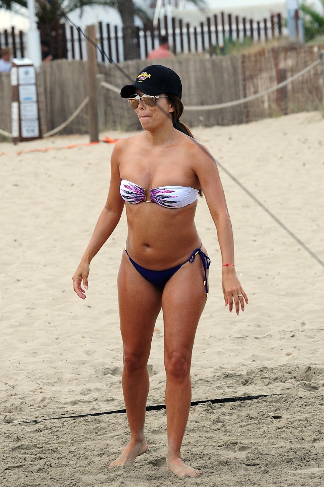 Eva Longoria flaunts her athletic figure in a bandeau bikini during a game of beach volleyball in Ibiza.