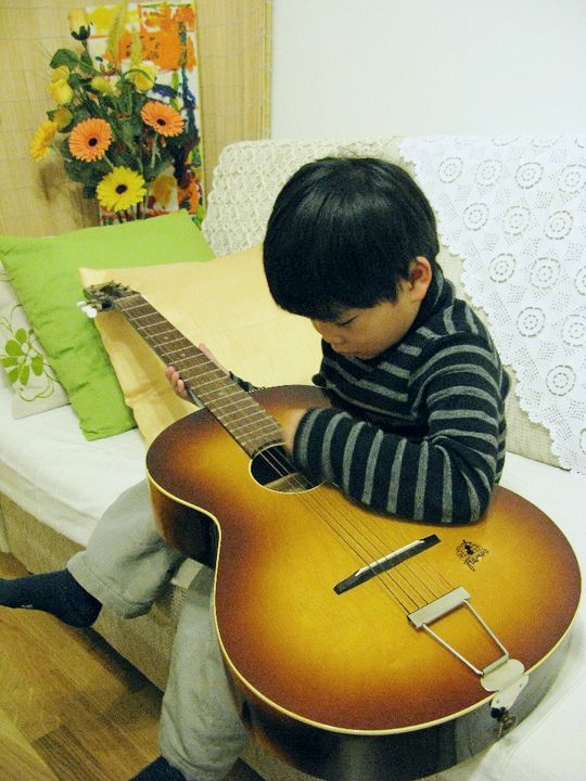 Music and Kids, Some Positive Ways They Benefit From, left-handed boy guitar