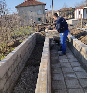 Halil throwing stones in for drainage