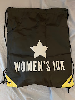 The black and yellow race drawstring back that says Women's 10k on it.