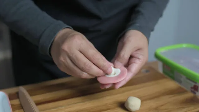 Flatten the pink dough and place white dough in the middle.