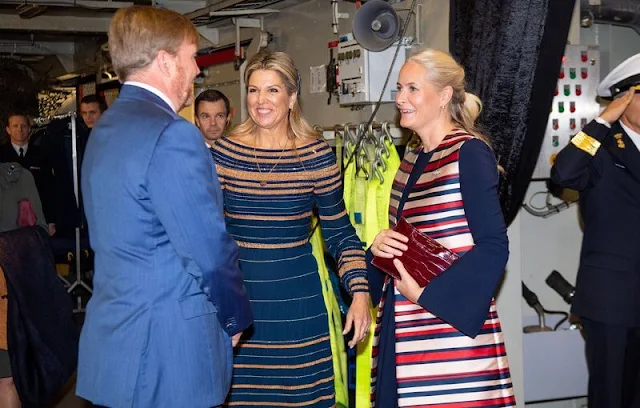 Crown Princess Mette Marit wore a satin stripe sleeveless trench coat by Tome. Queen Maxima wore a navy and beige dress by Jan Taminiau