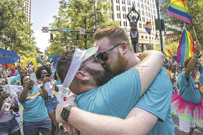 Men kissing after Mariage proposal at Pride Parade, Aug. 18, 2019