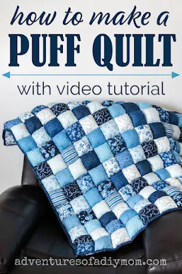 blue and white puff quilt draped over a brown leather chair
