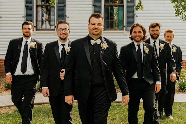 groom and groomsmen in black suits