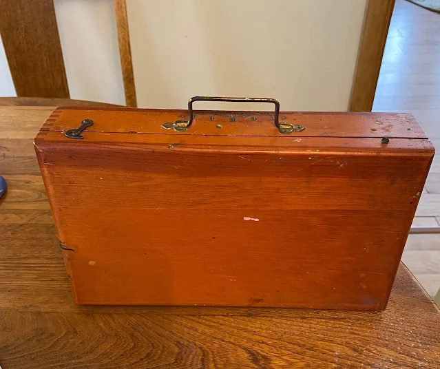 Photo of a vintage wooden artist paint case.