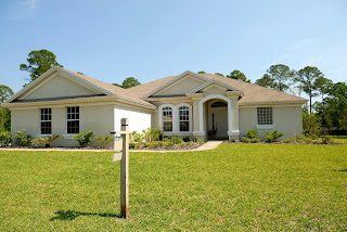 White and Brown Concrete Bungalow Under Clear Blue Sky