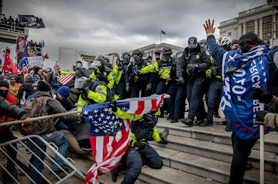 color photograph of supporters of President Trump battling law enforcement on the West steps of The Capitol on January 6, 2021, Washington, DC