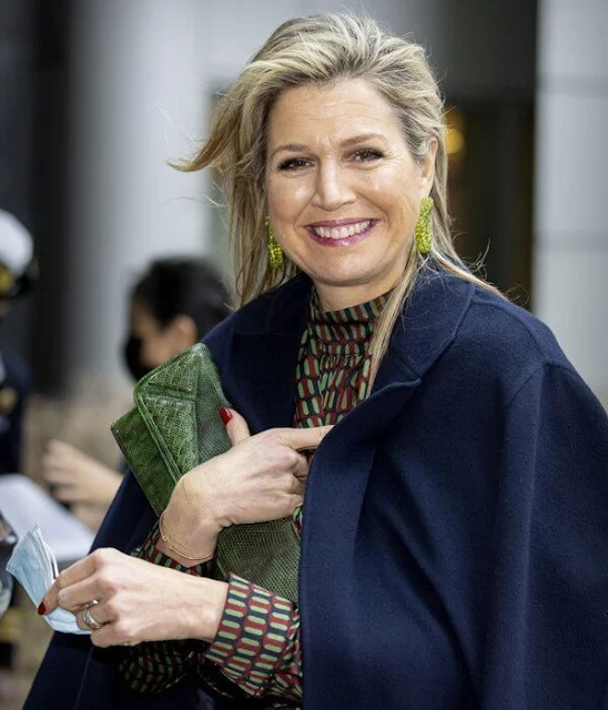 Queen Maxima wore a geometrical print viscose blouse from Natan, and a green leather skirt. Navy wool coat. Bodes and Bode earrings