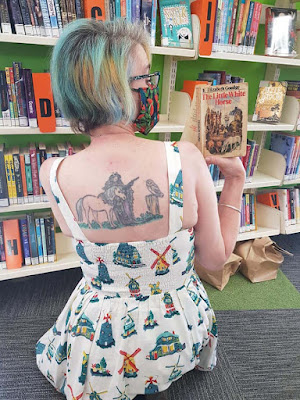 Anne from Helensville Library holding a book