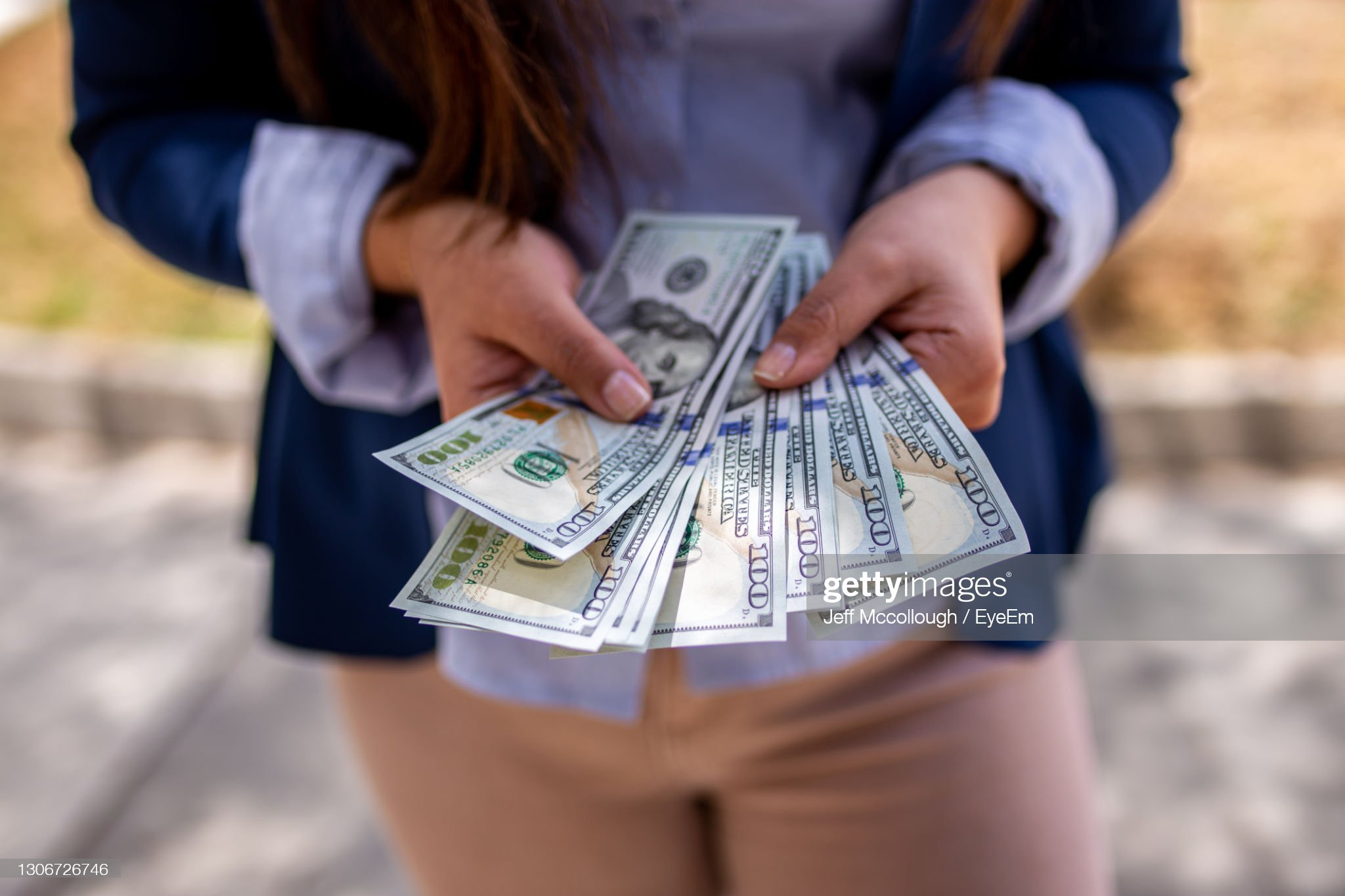 Midsection Of Woman Holding Banknotes