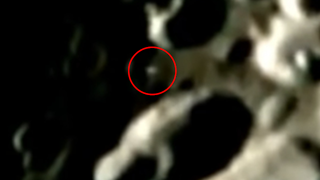 This is a real UFO sighting that is coming up and out of a crater on the Moon which flies upwards and to the left on the screen.