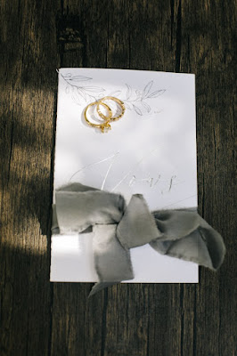 white vow book with gray ribbon