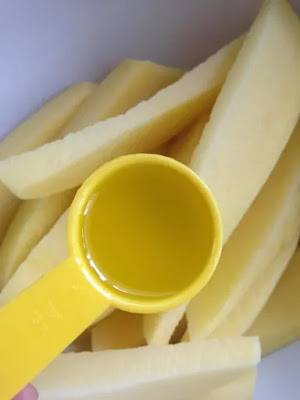 Potato wedges coated in olive oil