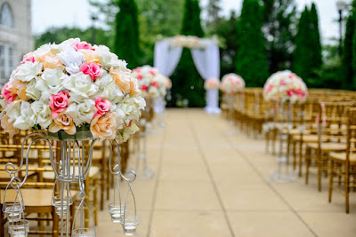 Outdoor wedding with aisle and flowers