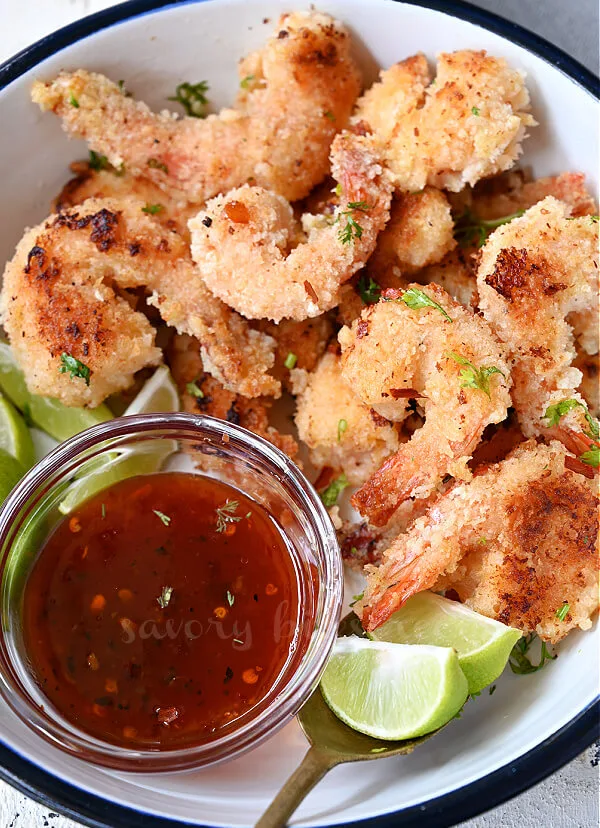 a closer look at white plate with crispy coconut shrimp