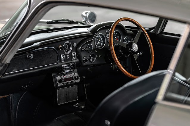The 1963 - 1966 Aston Martin DB5 dashboard and the reclining seats (unfocused foreground)