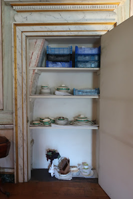 cupboard with shelves and portion of arch