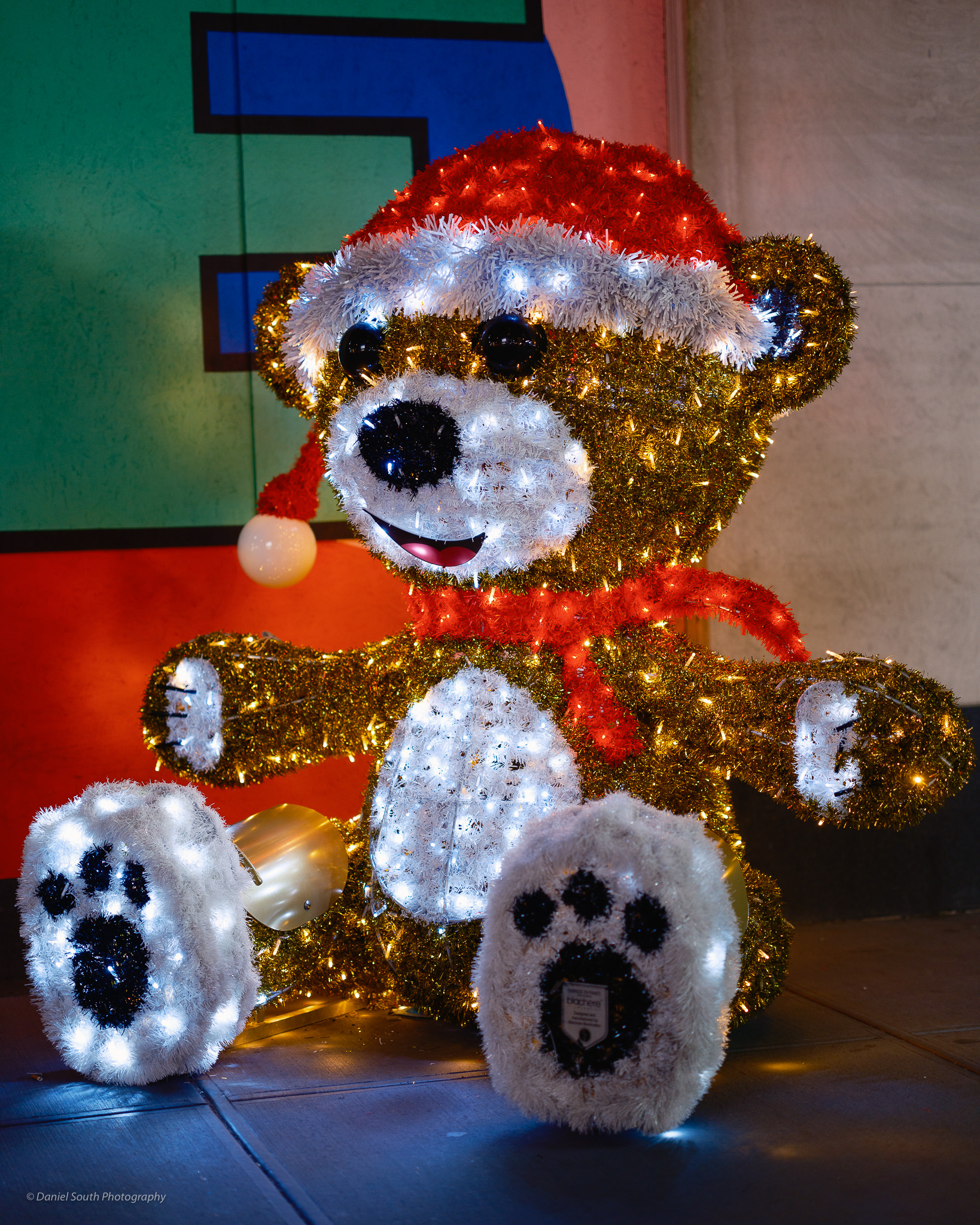 a photo of a tinsel teddy bear in new york at christmas