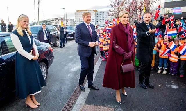 Queen Maxima wore Sirius wine-red coat by Claes Iversen. Crown Prince Haakon and Crown Princess Mette-Marit