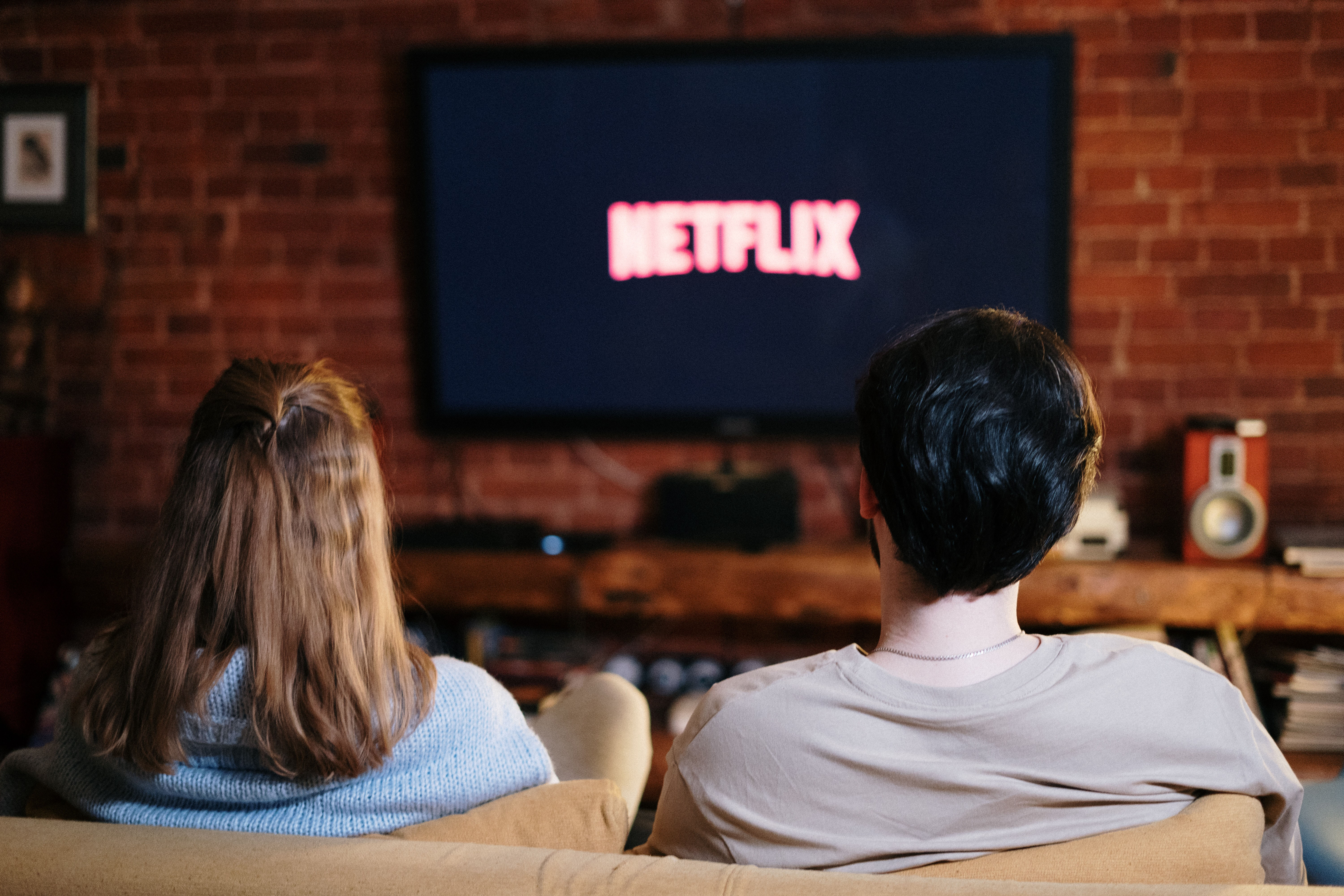 Couple watching Netflix sets the scene for Is This Mutton's February 2022 reviews of TV, books and podcasts
