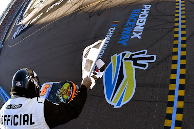 Noah Gragson takes the checkered flag to win the NASCAR Xfinity Series United Rentals 200 at Phoenix Raceway on March 12, 2022 in Avondale, Arizona.