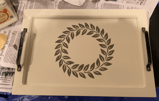 Photo of a serving tray with laurel wreath stencil & C monogram.