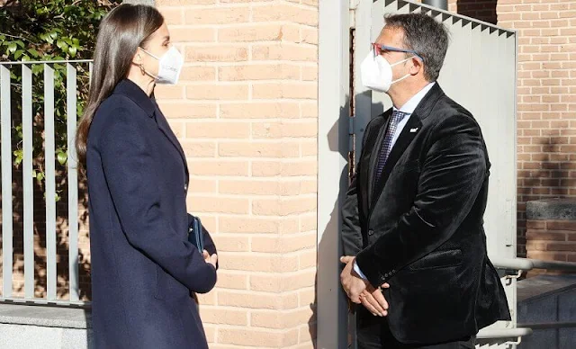 Queen Letizia wore kocani striped blazer and trousers suit from Hugo Boss, and navy wool coat from Hugo Boss