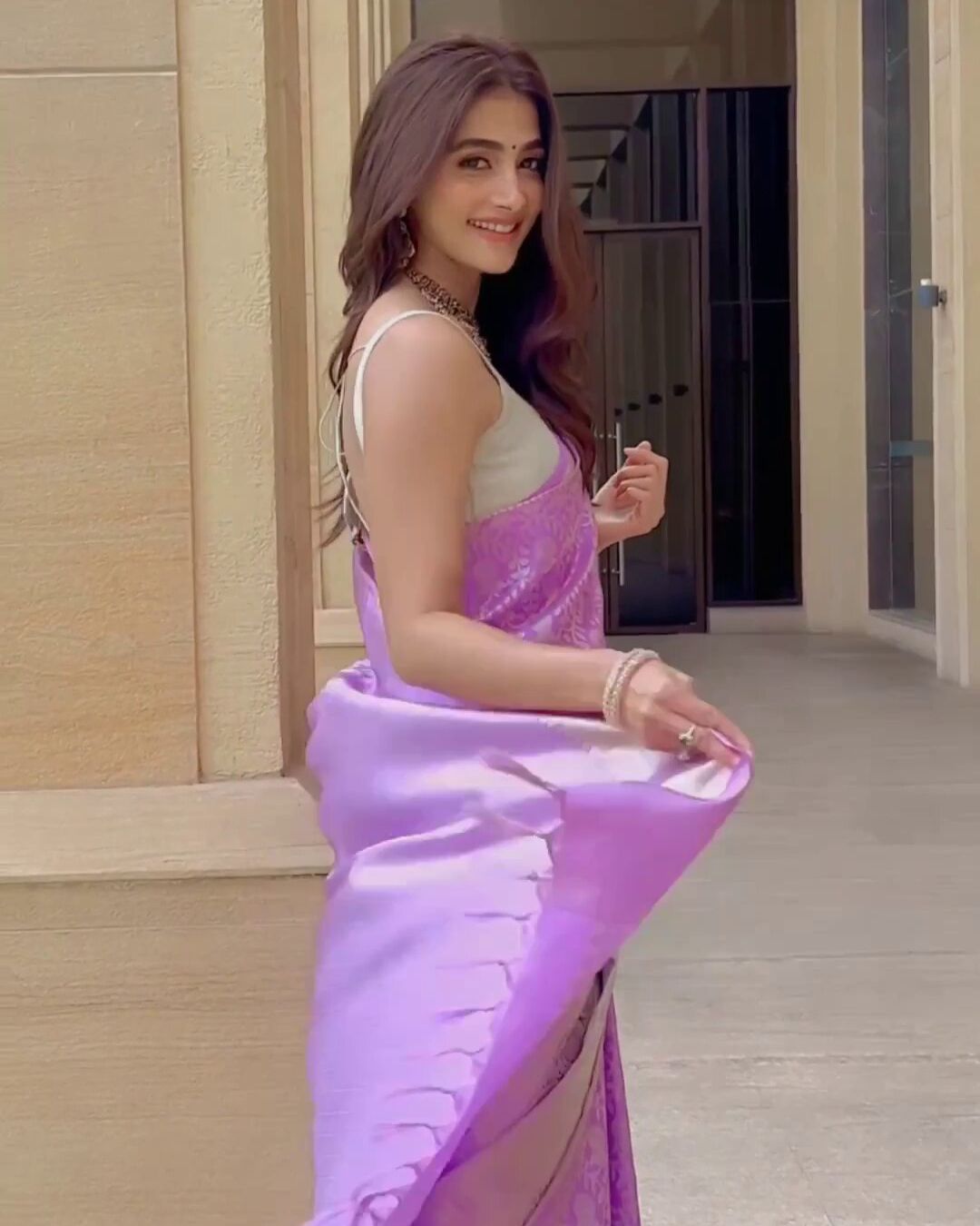 Pooja Hegde looks stunning in Purple Banarasi saree with strappy blouse