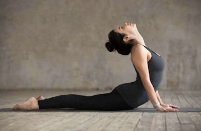 A women doing Bhujangaasana or Cobra Stretch