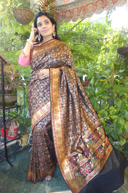 Banarasi silk saree. With Patola like Navratan body and Paithani like border and pallu- black, Blue and silver