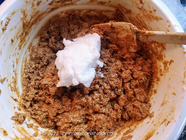 Fold egg whites into Christmas plum cake batter