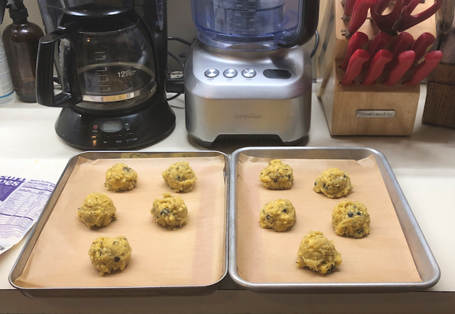 Mounds of prepared Livlo keto blueberry scones mix dough on parchment lined baking pans