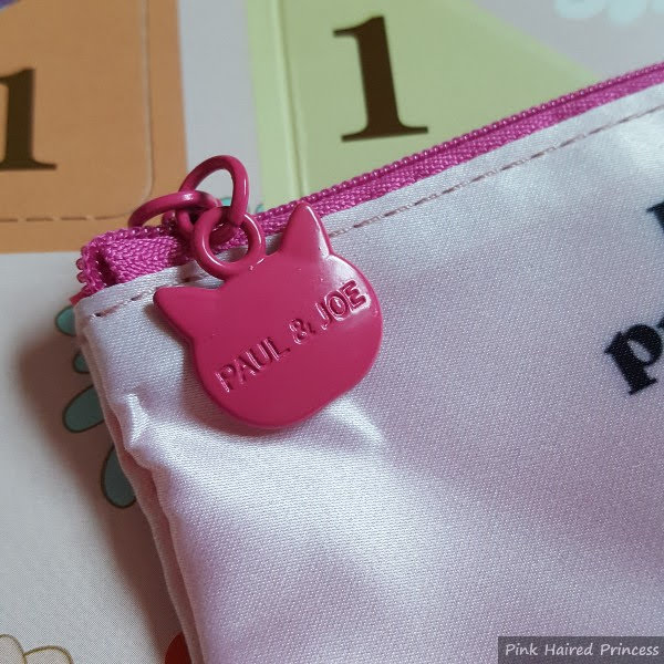 close up of pink cat shaped zip pull on makeup bag