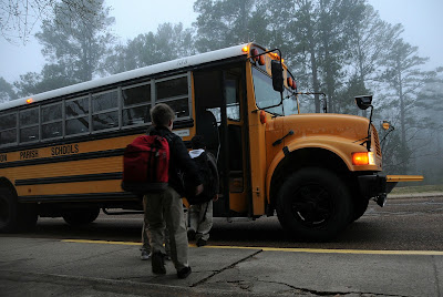 Kids getting on yellow School Bus