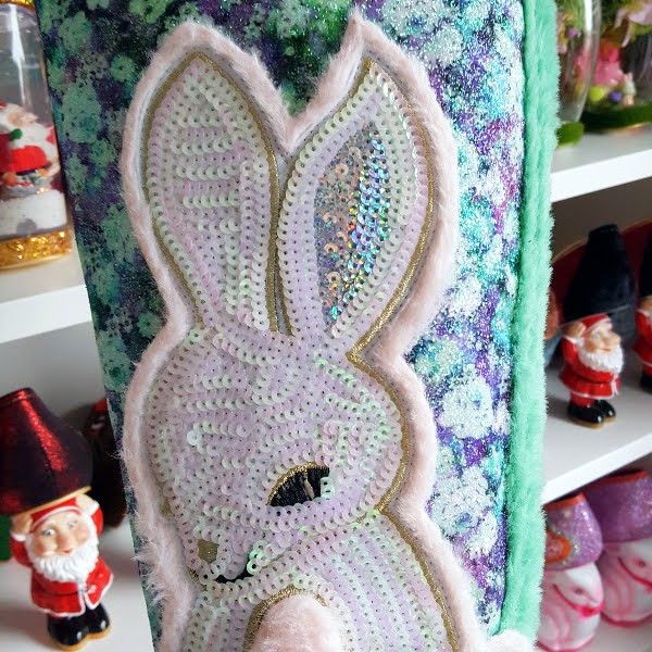 close up of fur and sequins bunny on side of knee high boot