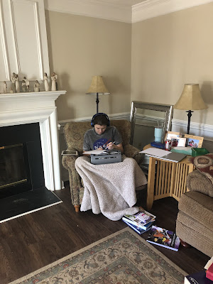 Photo of Elizabeth working on her braille.